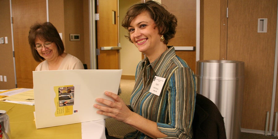 woman smiling opening folder