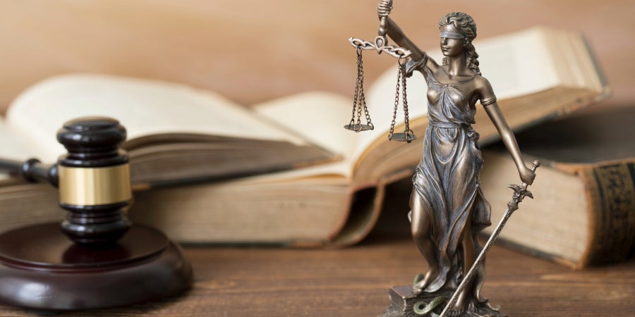 Law books with statue