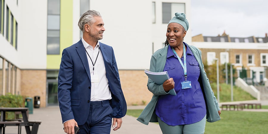 School administrators walking across campus