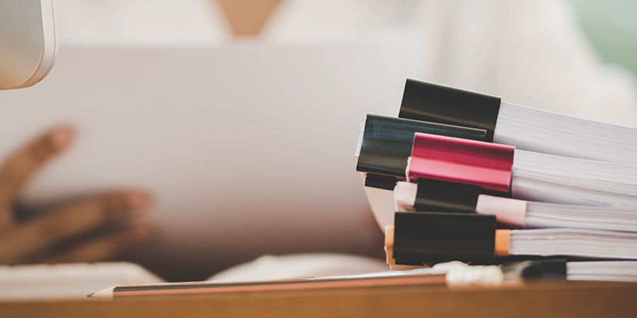 Photo of a stack of documents ready to be reviewed