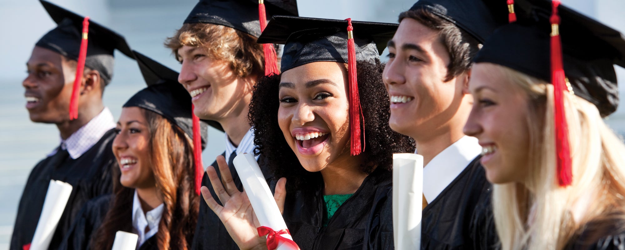 Students dressed in cap and gown at graduation
