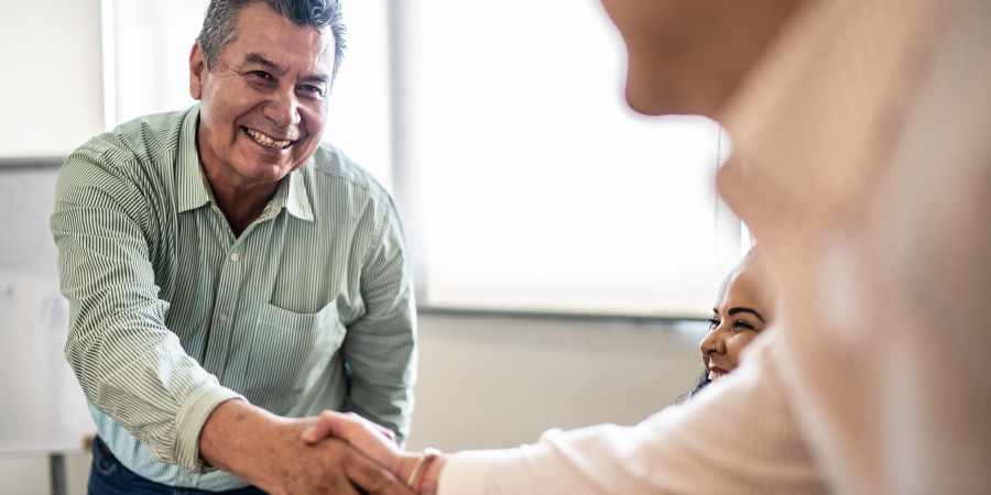 Person shaking hands in meeting